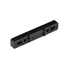 An elongated black plastic shim featuring several mounting holes and small alignment pins, used as a spacer for industrial equipment.